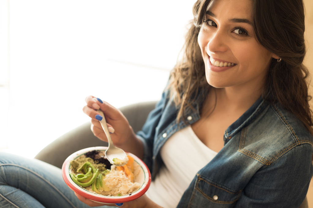 Woman eating a healthy bowl of superfoods